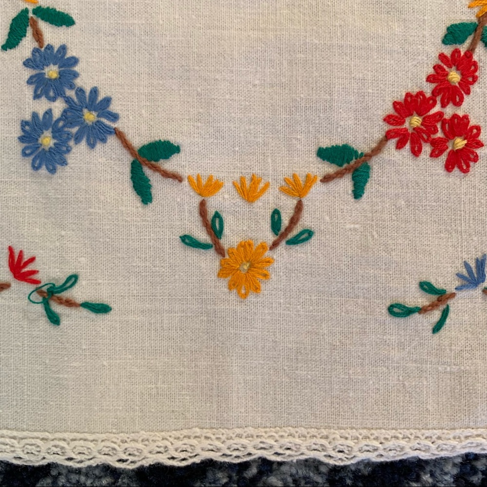 Pair of vibrant vintage hand embroidered floral linen doilies